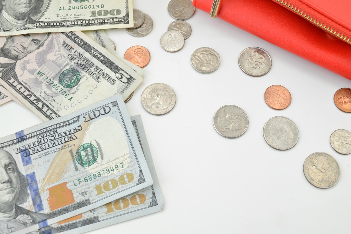 Personal finance planning with cash and a notebook