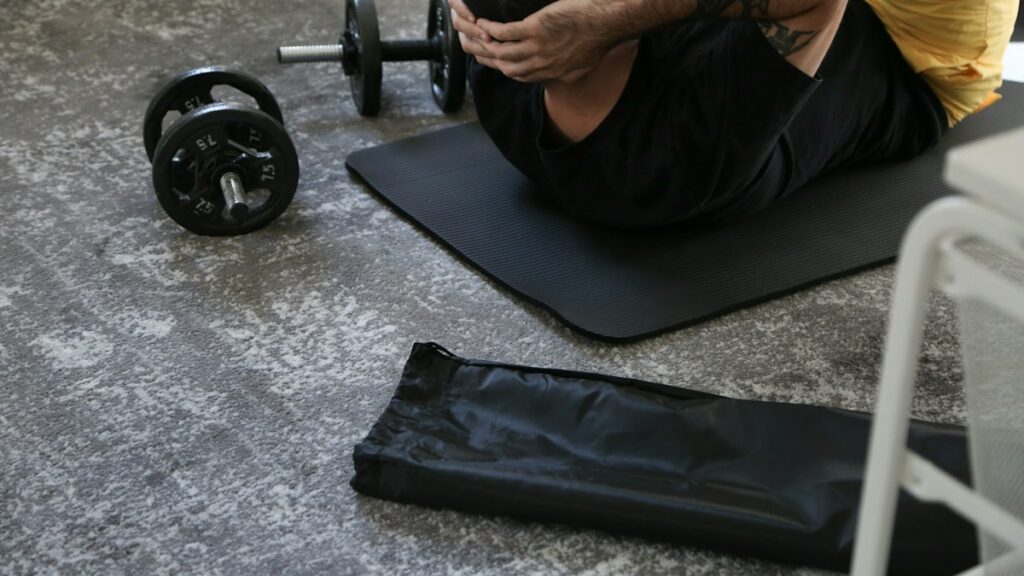 Man training with weights in a home gym
