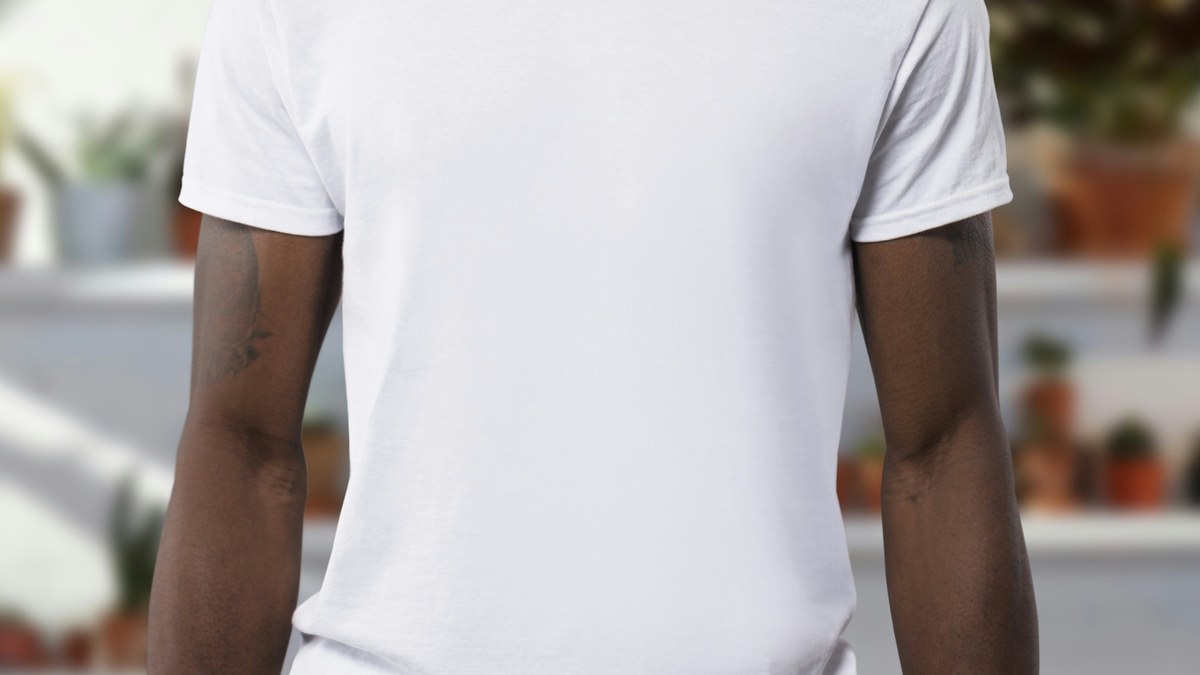 Man wearing a plain white short sleeved T shirt