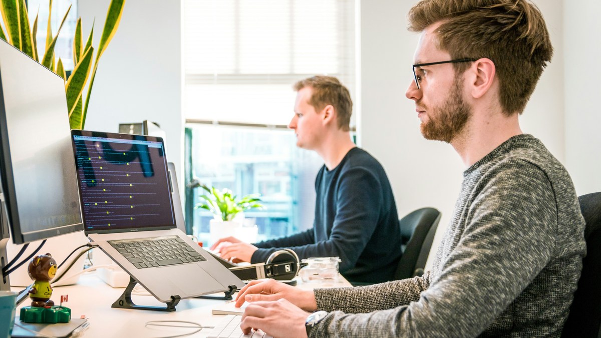 Two men working at computers in an office