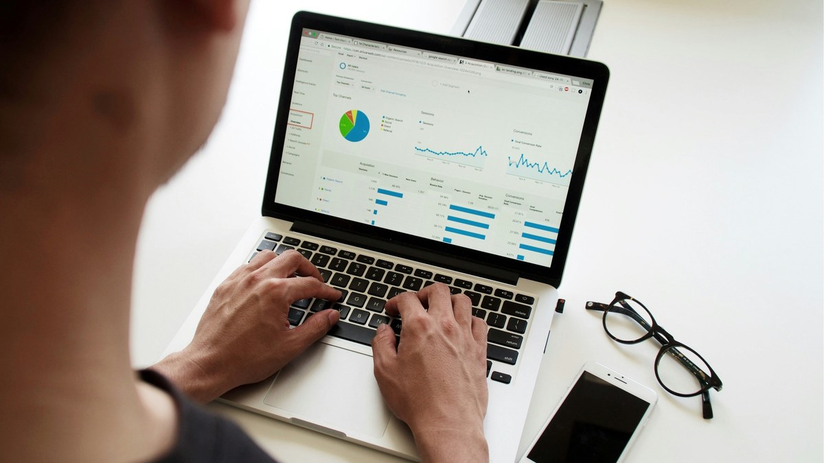 Person reviewing charts on a laptop at a desk
