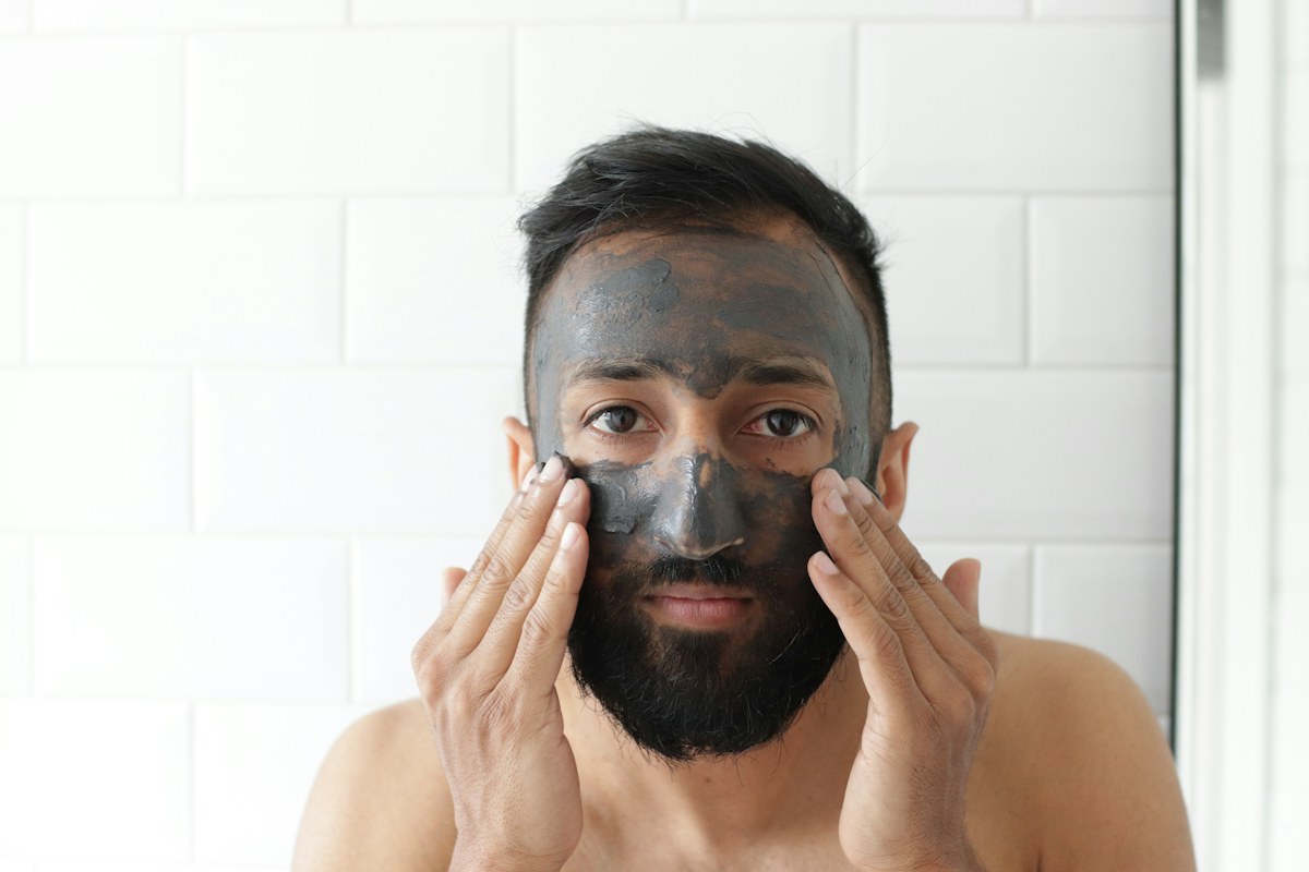 Man applying a facial skincare treatment