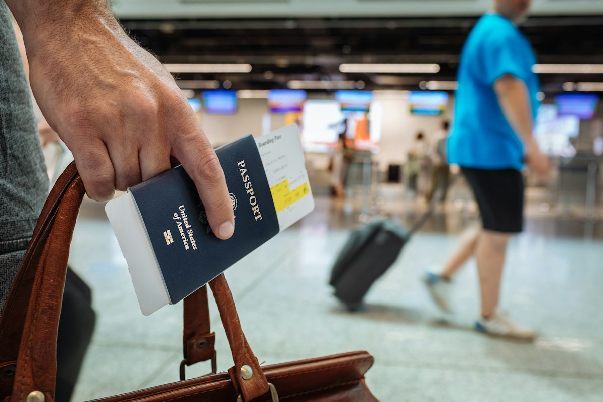 Traveler holding passport and documents before a trip