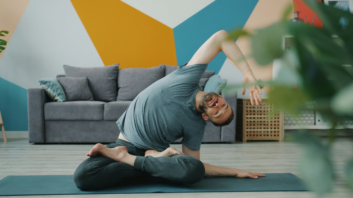 Man stretching at home