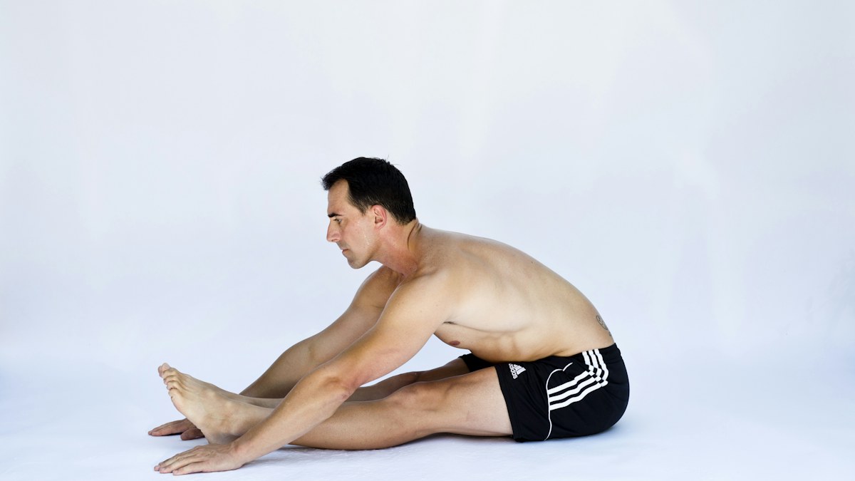 Man performing a floor based mobility exercise