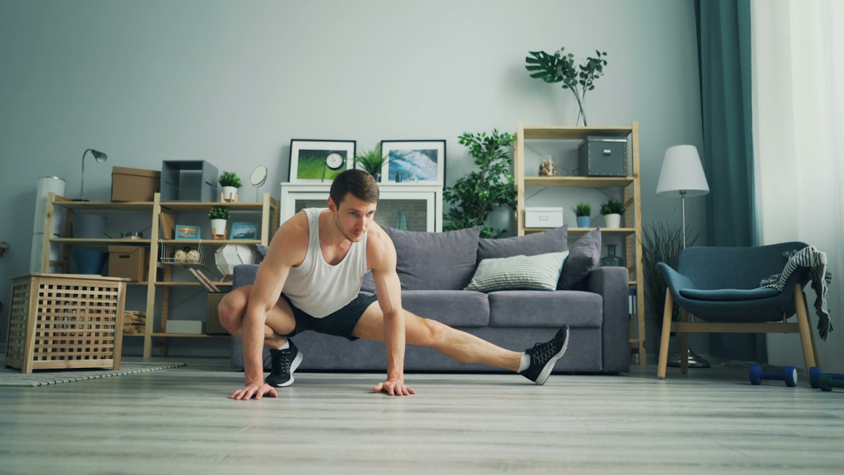 Man seated on the floor during a home mobility routine