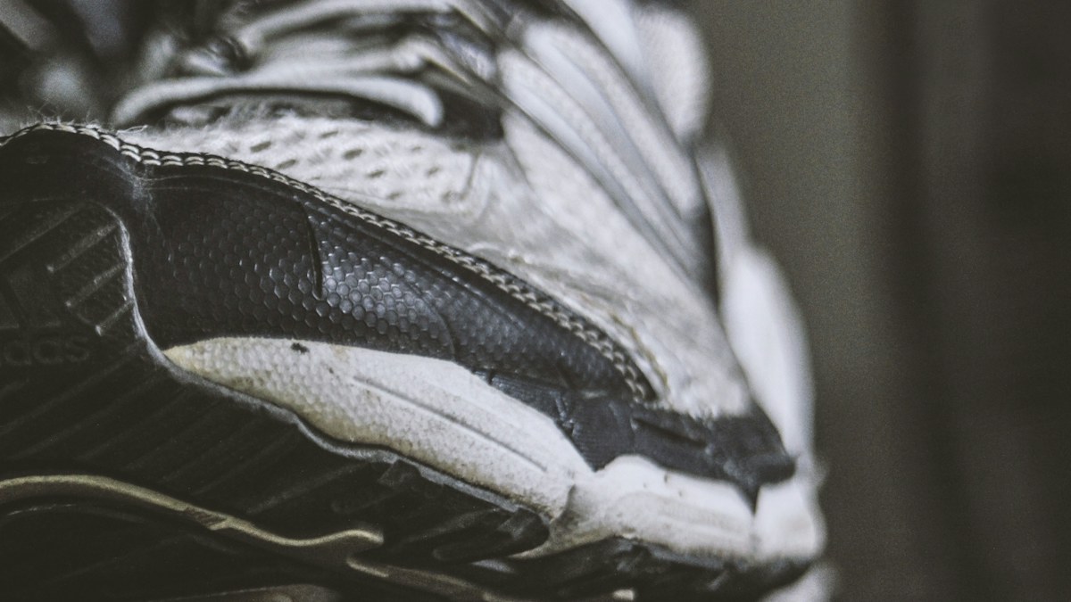 Close view of an athletic shoe showing details to inspect for wear