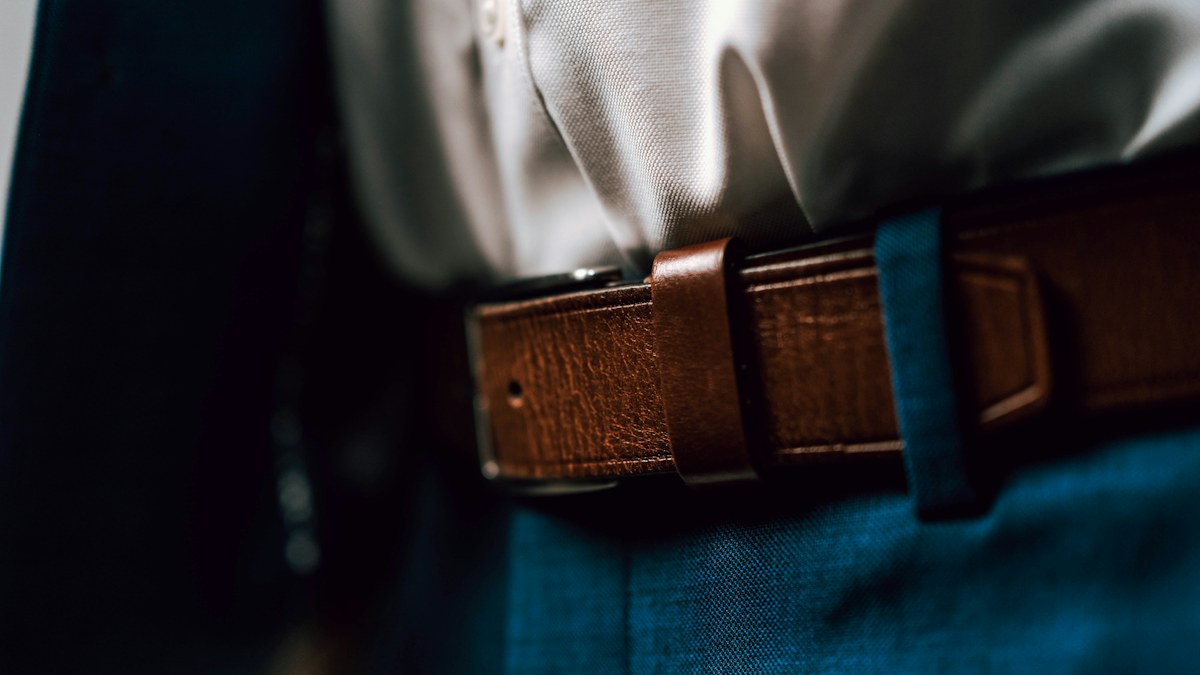 Black leather belt with blue denim illustrating casual accessory coordination