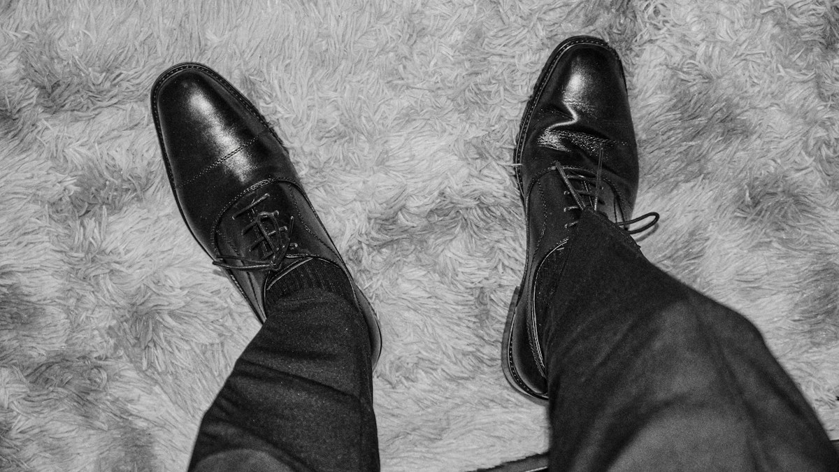 Pair of black leather dress shoes illustrating formal footwear coordination