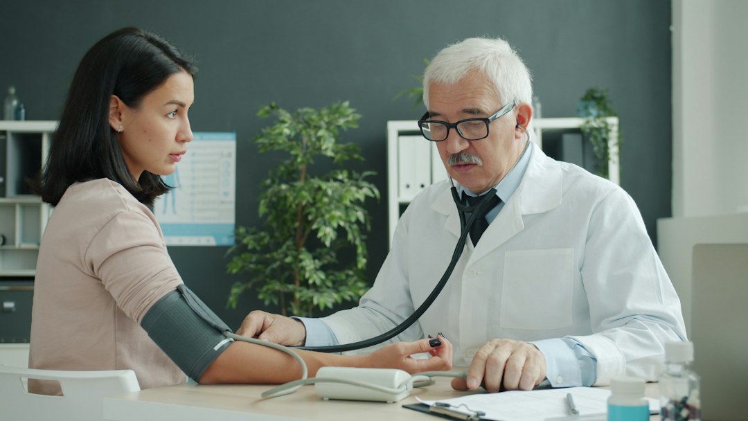 Clinician checking blood pressure during a consultation