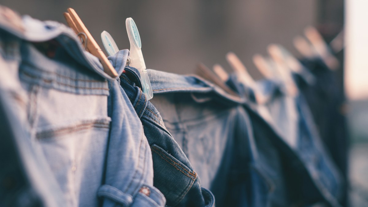 Denim jeans hanging outdoors to air dry after washing