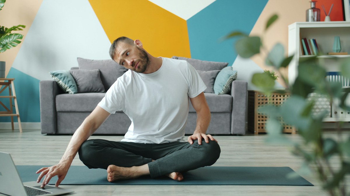 Man following an exercise tutorial at home