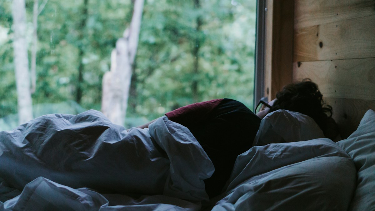Person sleeping under a blanket