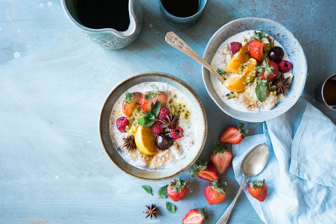 Bowl of oatmeal with a hot drink