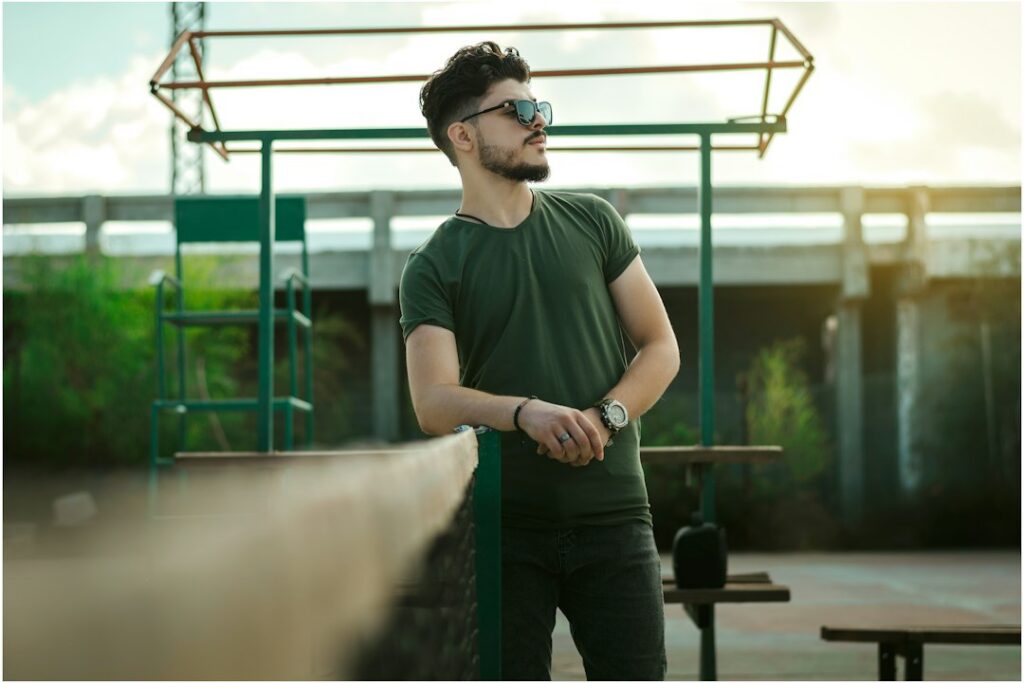 Man wearing a fitted green crew neck T-shirt