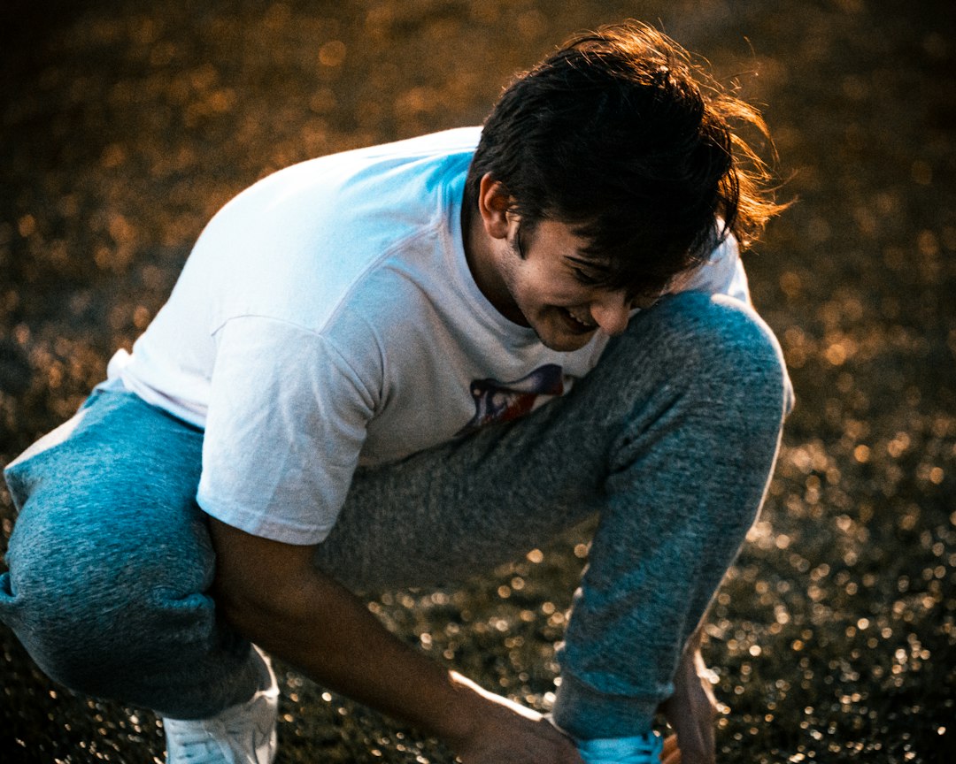 Man noticing pain around a knee after activity