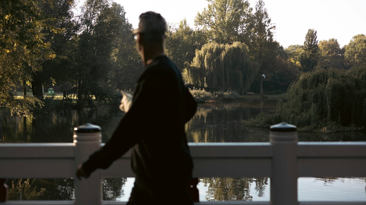 Man walking near a lake