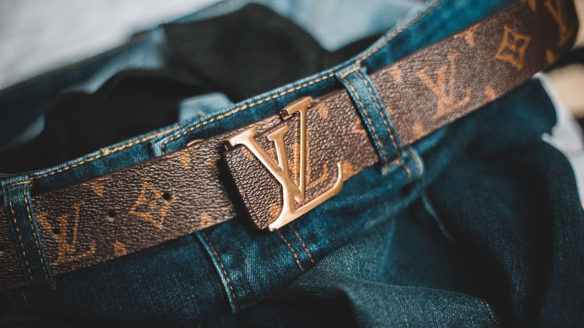 Leather belt worn with casual trousers and visible belt loops