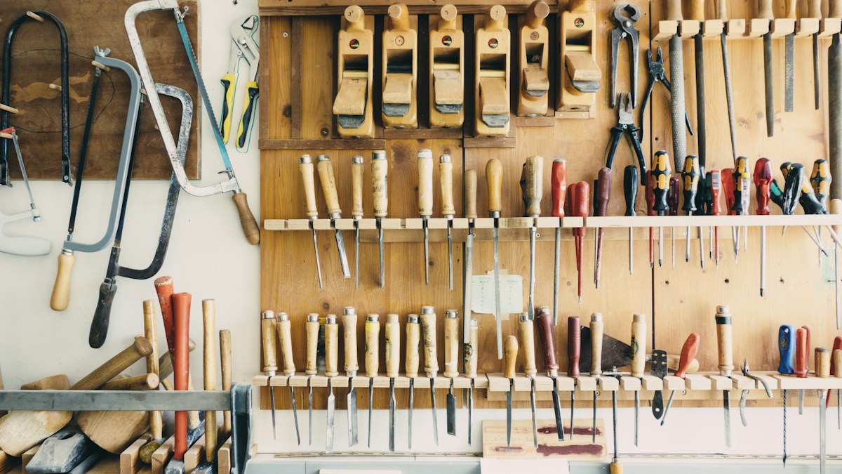 Assorted woodworking hand tools mounted on a wall