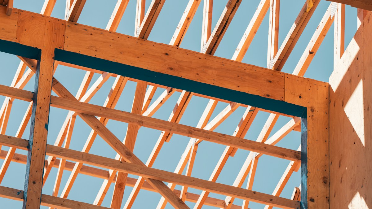 Wooden building framework against a blue sky