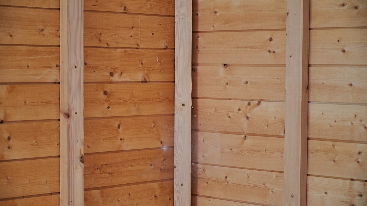 Timber-lined wall with vertical wooden supports