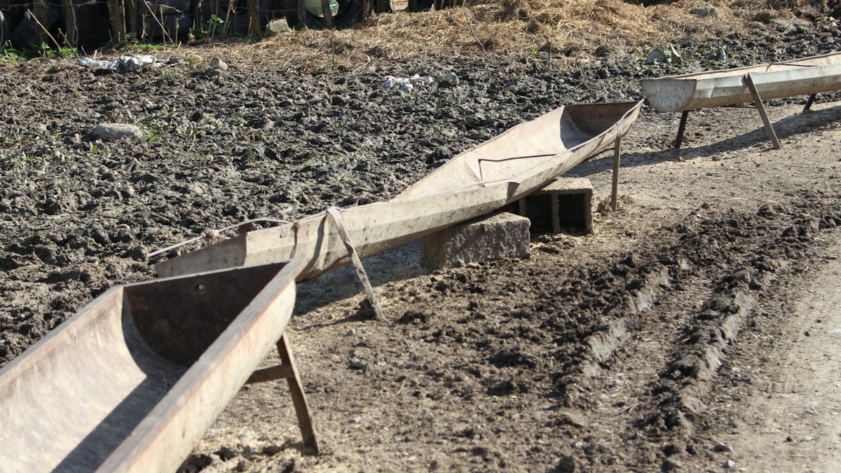 Small wooden boats resting on dry ground