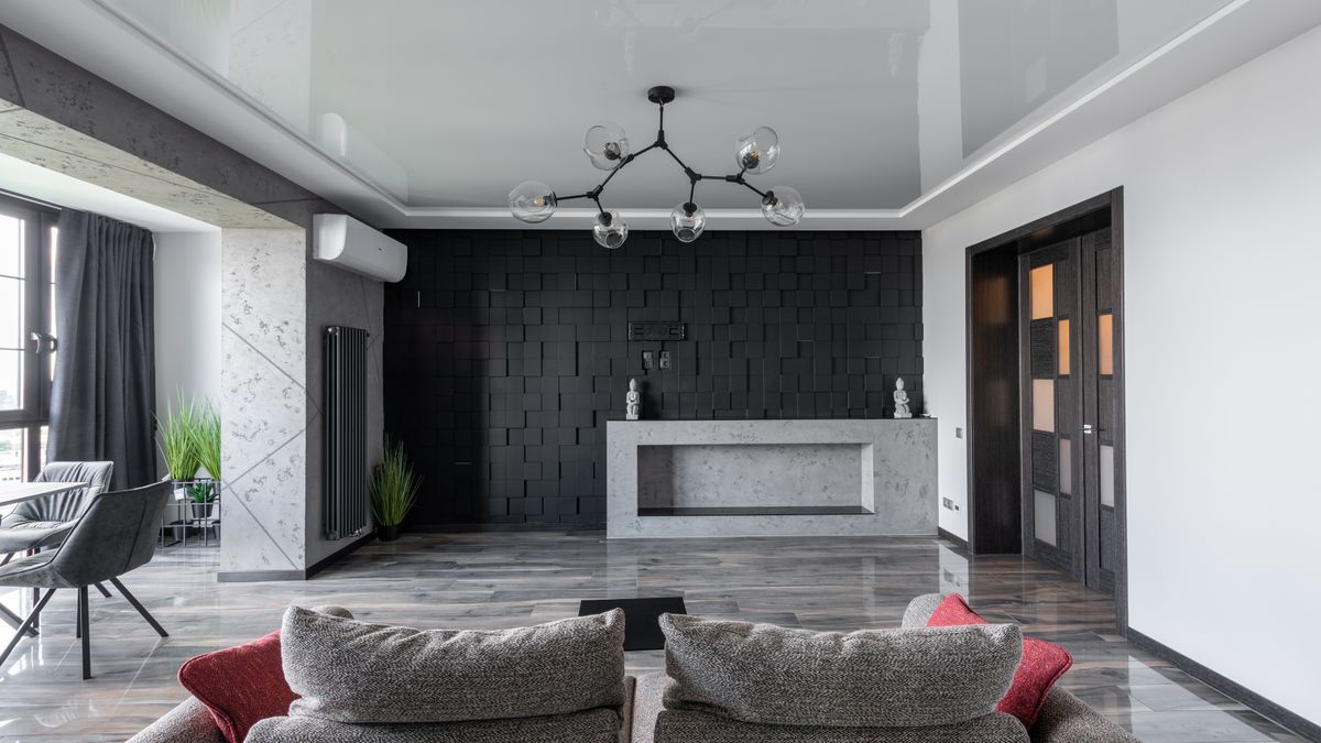 A dark painted feature wall behind contemporary living-room seating