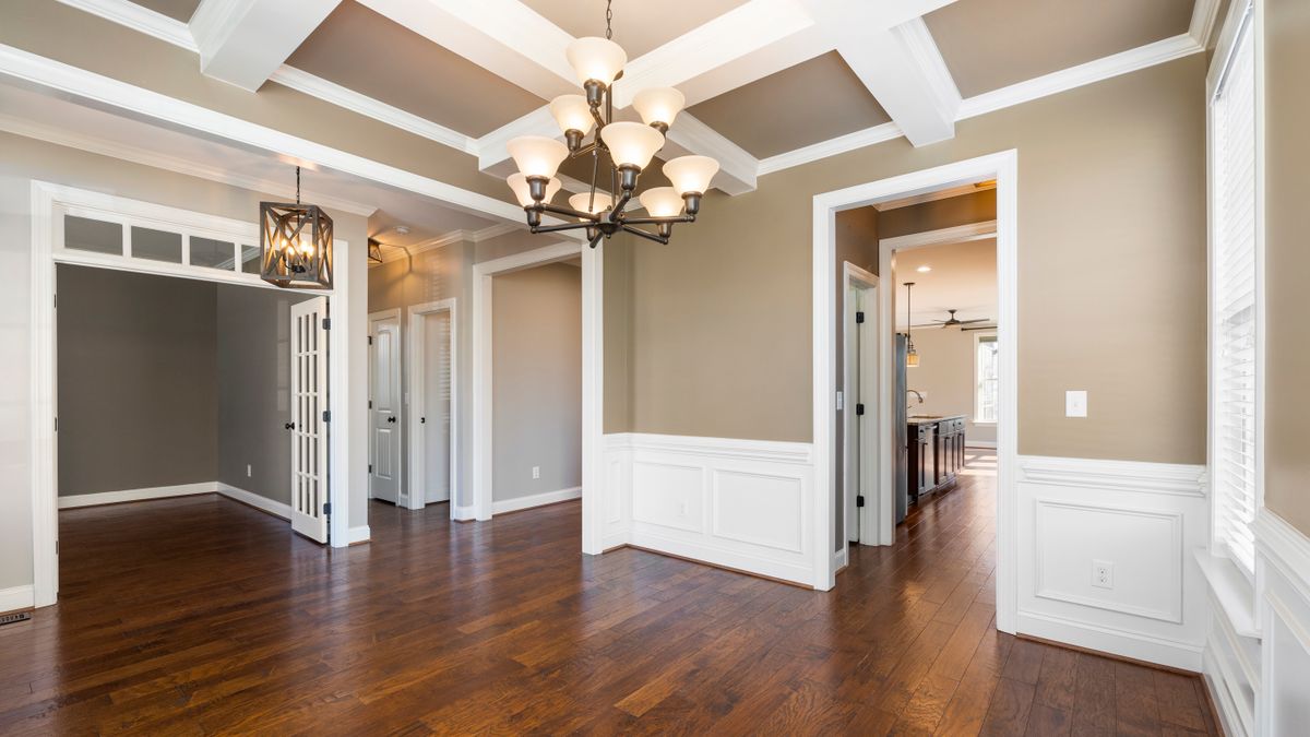 Interior with pale wall wainscoting beneath decorative trim