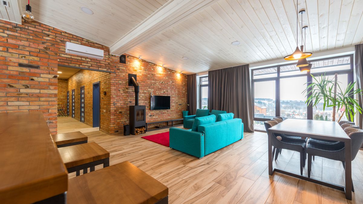 Exposed brick provides a focal surface in a modern living room