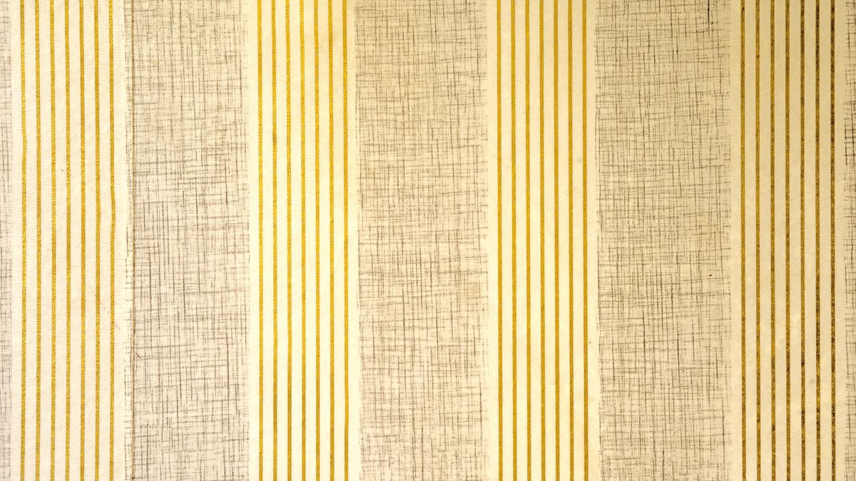 Close-up of beige and gold vertically striped textured wallpaper