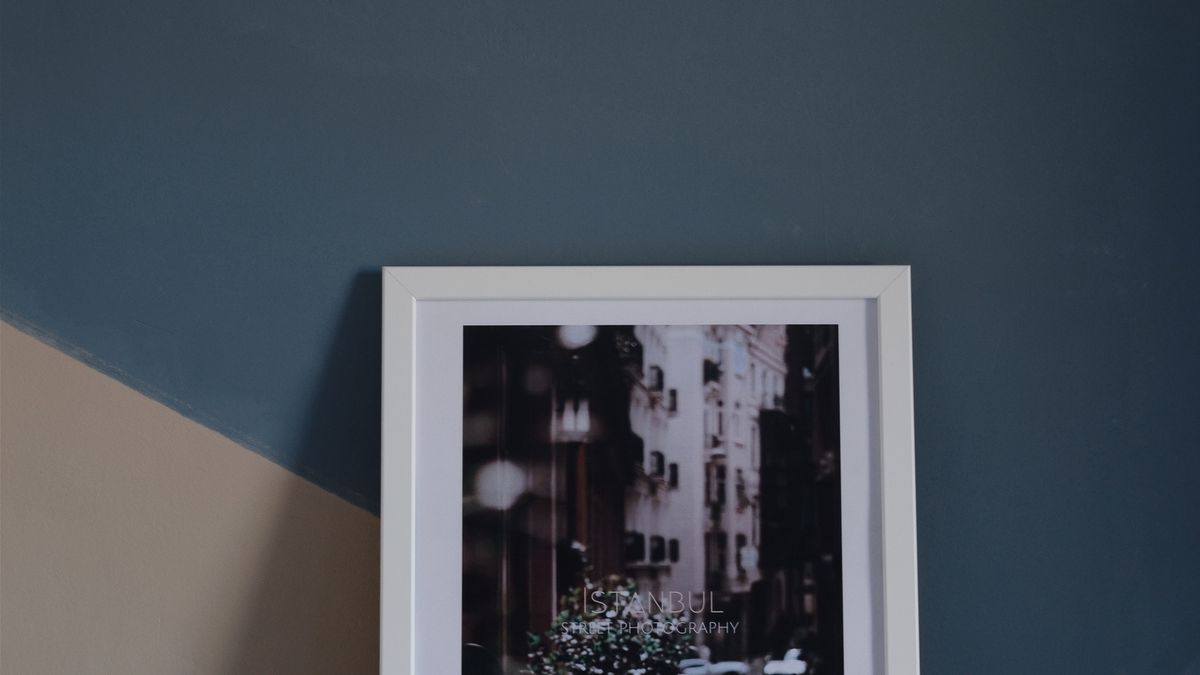 Framed artwork placed over a geometric painted color-block wall