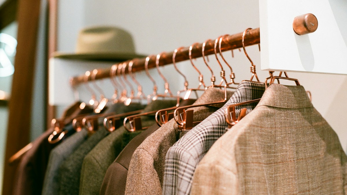 Neatly hung clothing on a compact wardrobe rack
