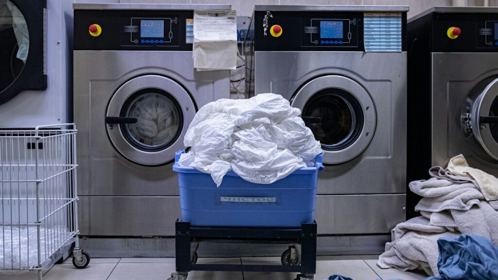 Washing machine beside laundry basket