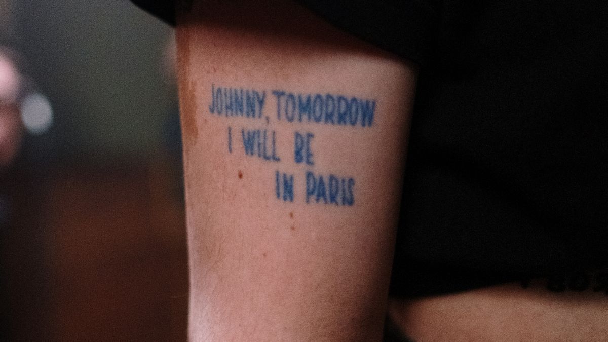 A visible phrase tattoo illustrates lettering on an arm
