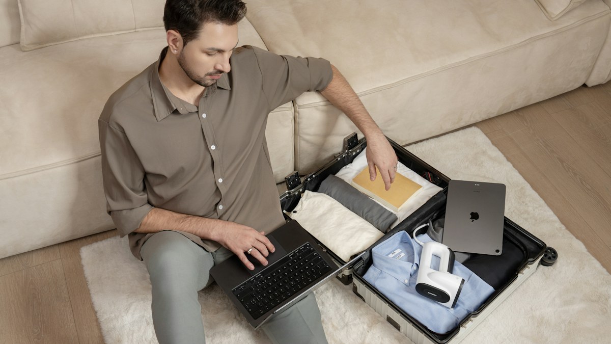 Man packing a suitcase with clothes before a trip