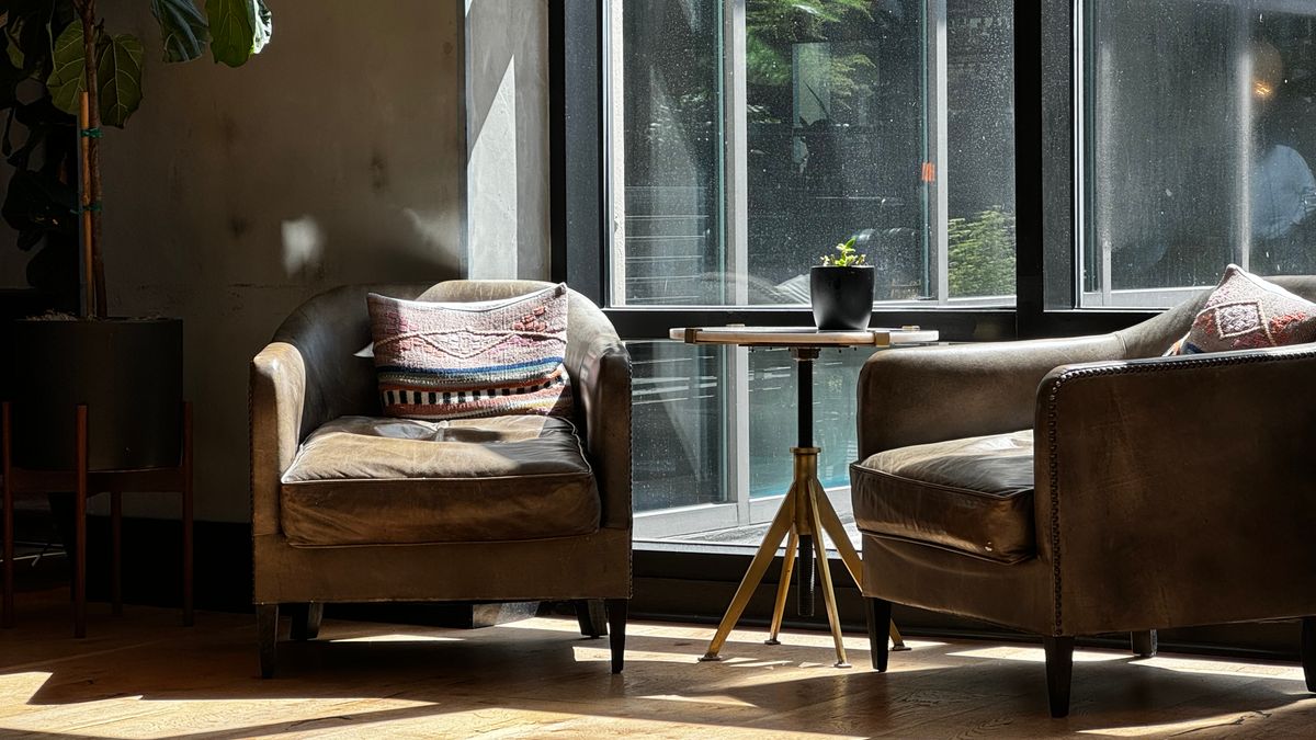 Two armchairs frame a small conversation zone by a window