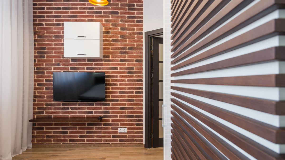 A TV wall incorporating lower closed storage and open shelf space