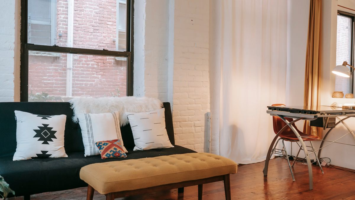 A slim bench alongside living room furniture offers occasional extra seating