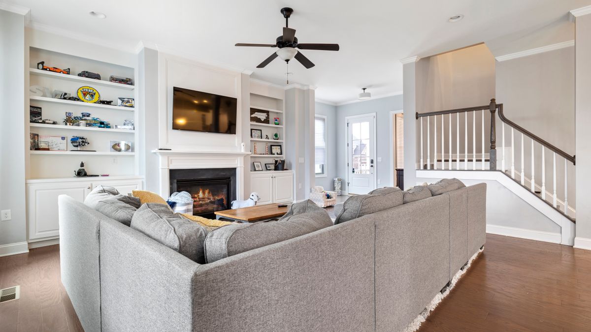 A fireplace forms a clear focal point in a furnished living room