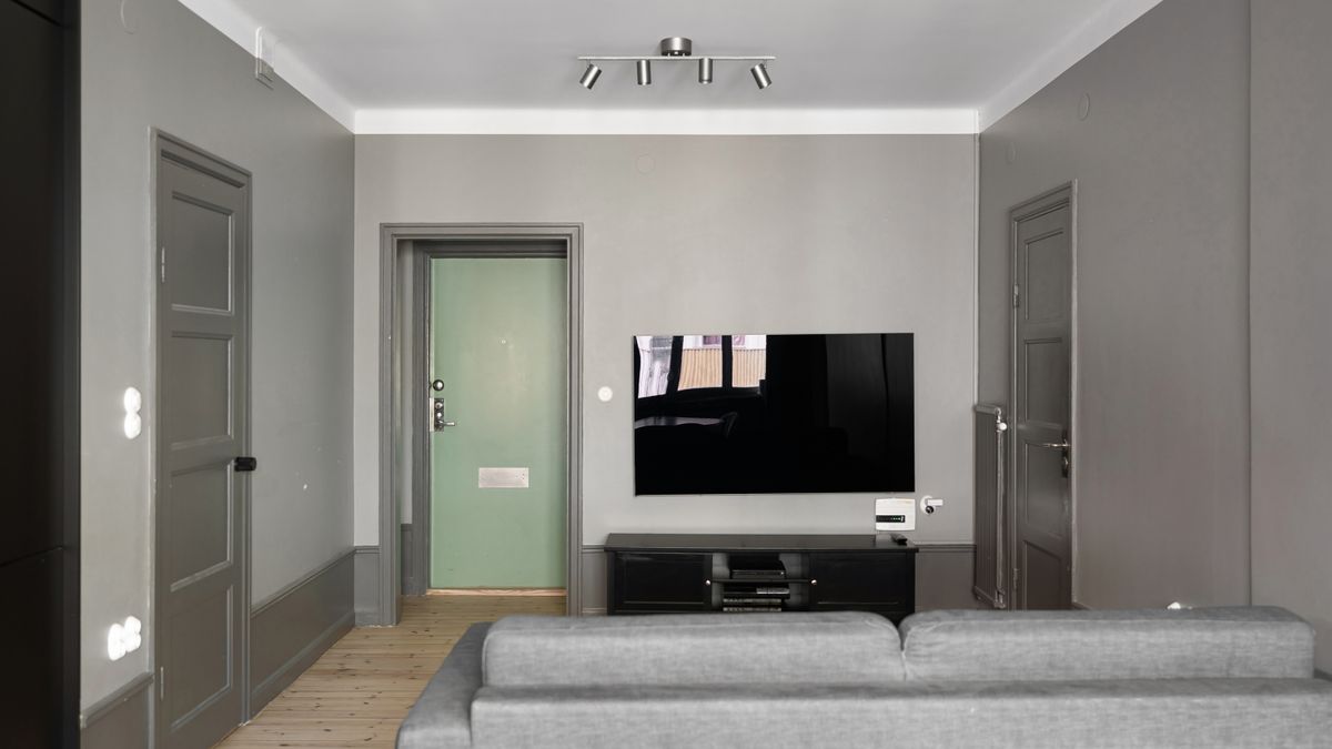 A minimalist television wall with a slim, unobtrusive media console