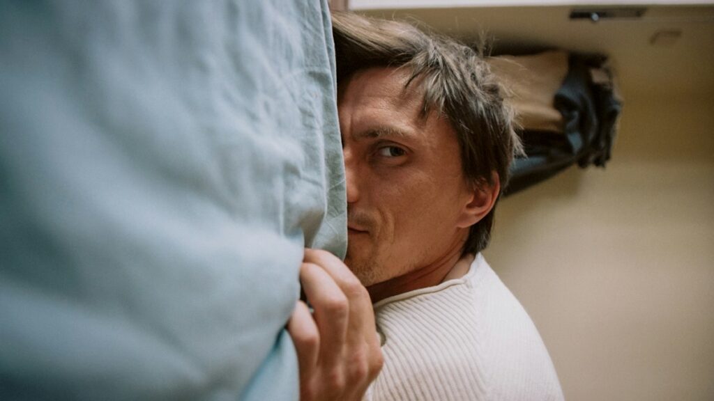 Man resting with his head on a pillow