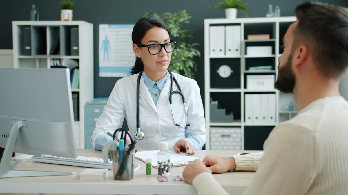 Man discussing care with doctor