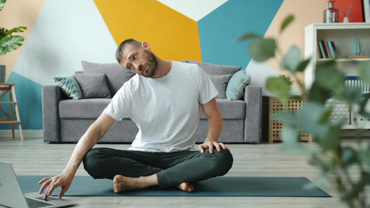 Man stretching at home