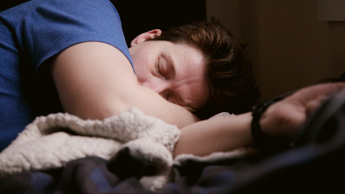 Man resting in bed before work