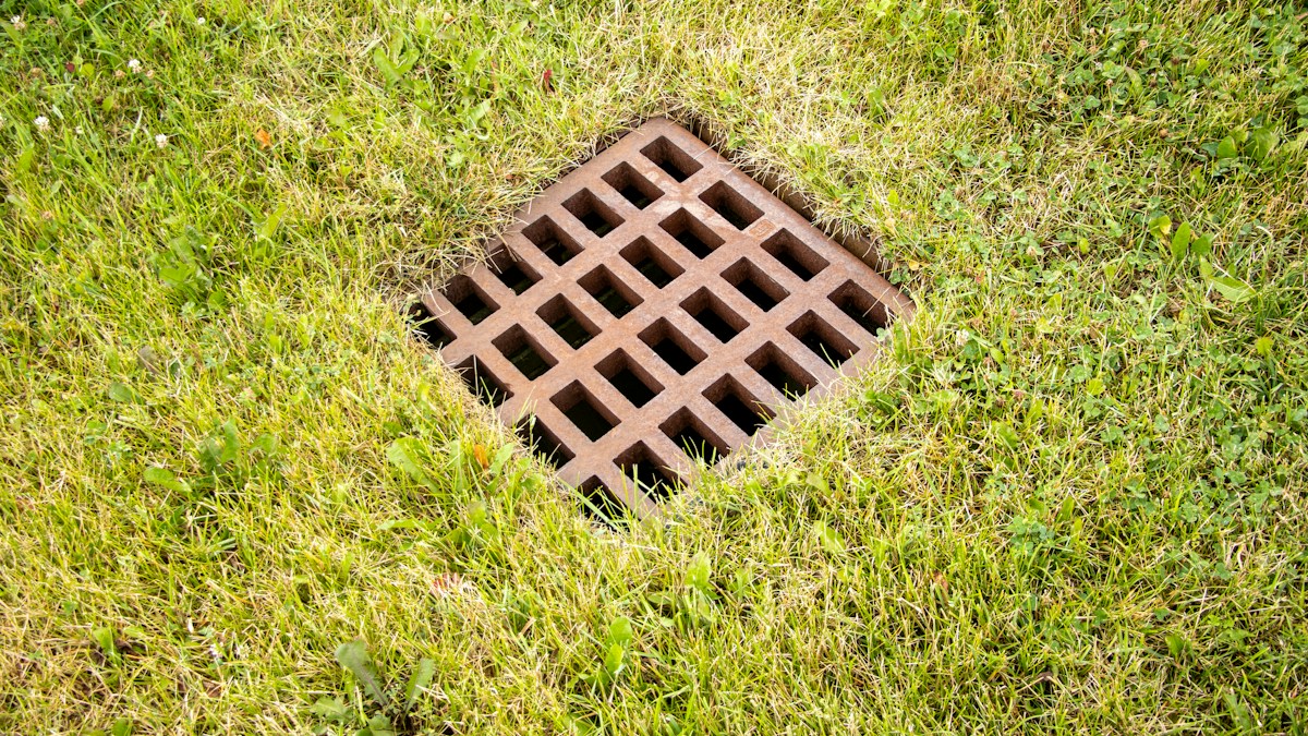 Ground drainage fitting in grass