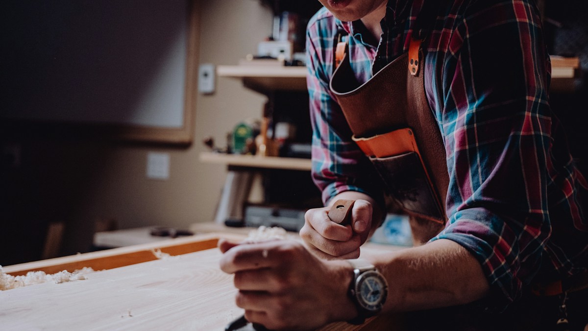 Man preparing timber in a woodworking shop