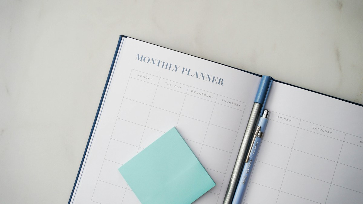 Paper planner and pen on desk