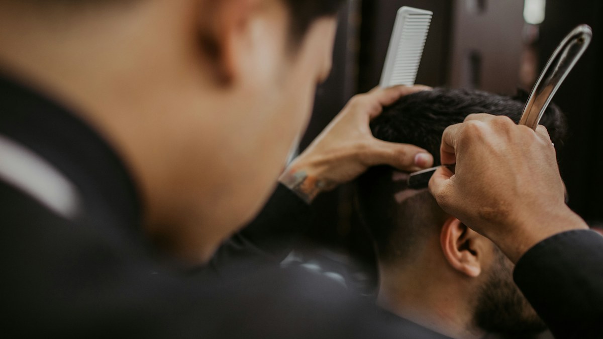 Barber trimming a man's hair