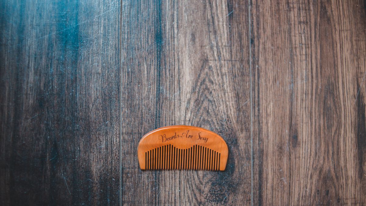 Hairbrush and metal barber tools on a stone tabletop