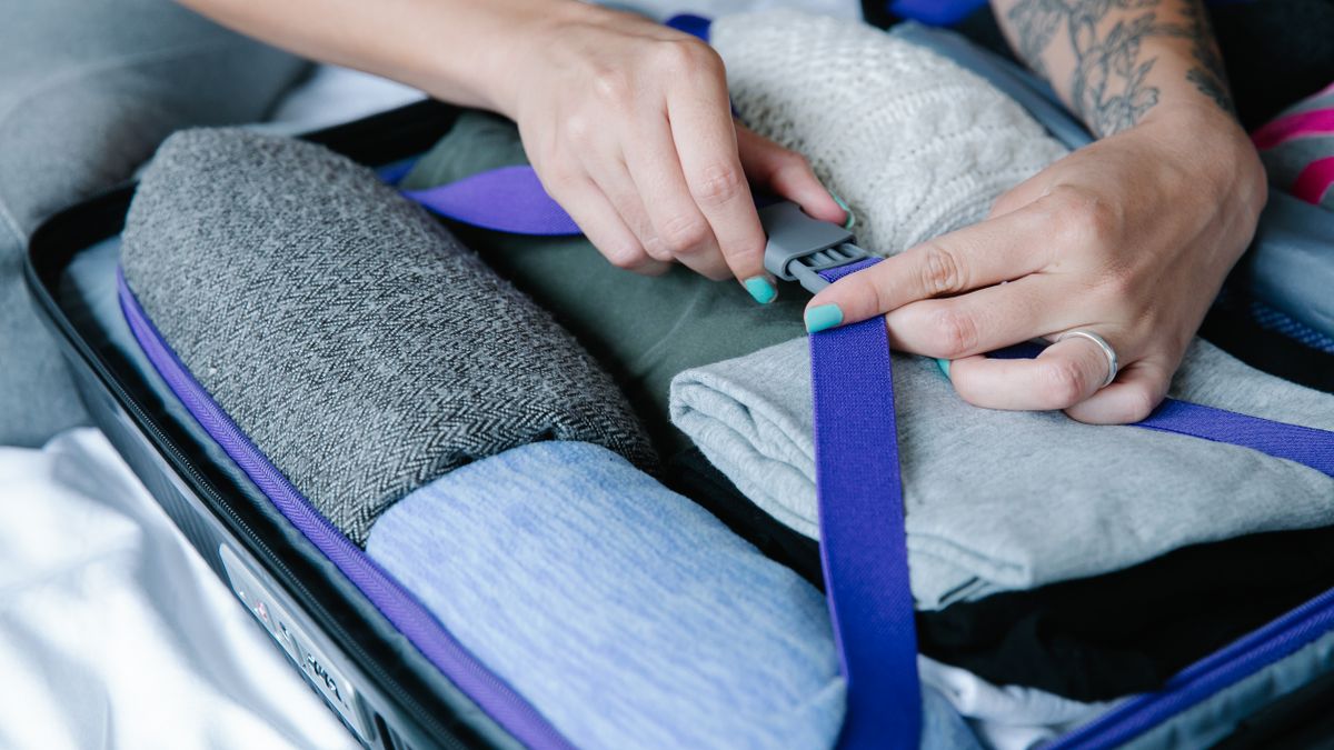 Folded clothes secured inside a suitcase.